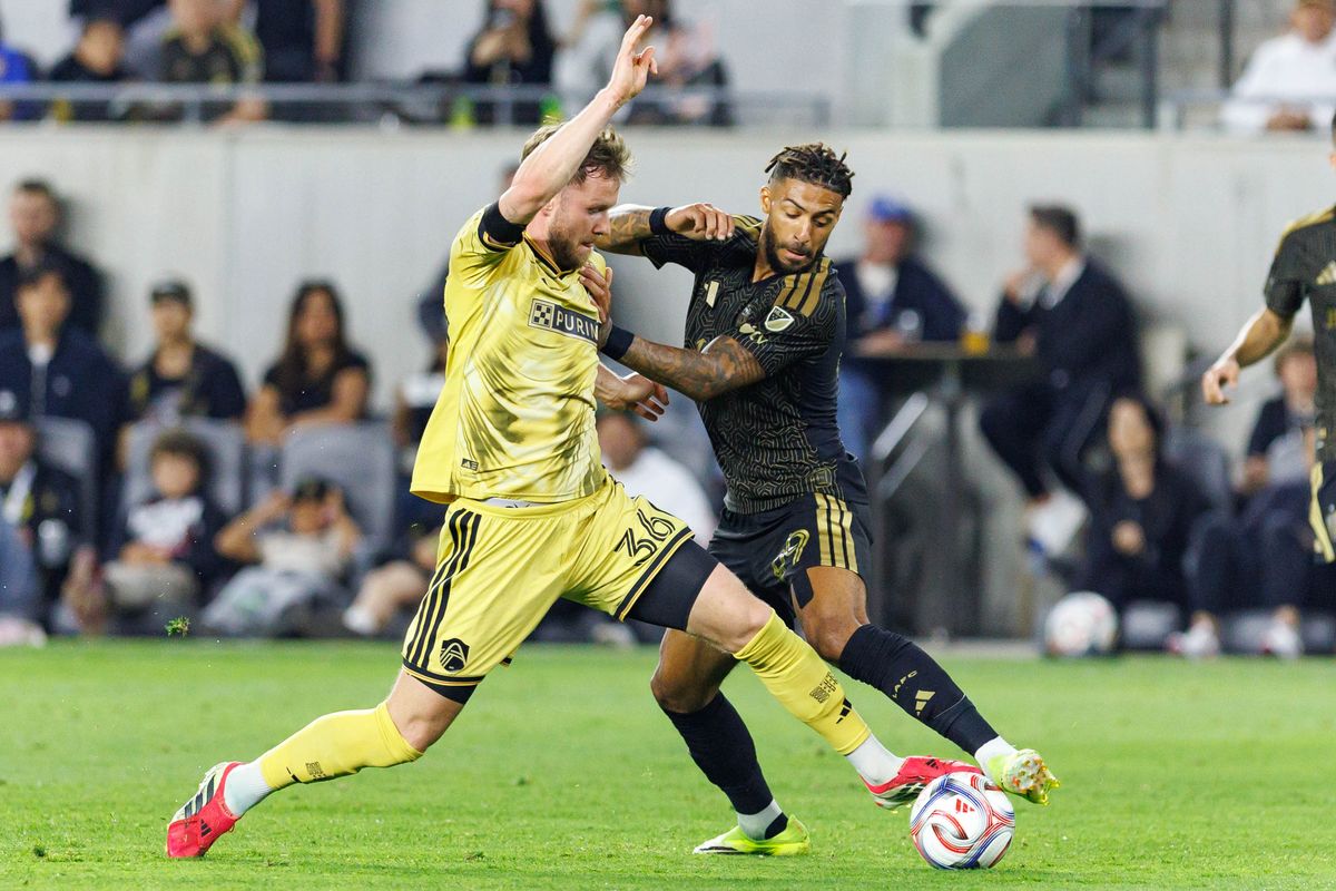 St. Louis FC forward Cedric Teuchert (#36) defends the ball from forward Denis Bouanga (#99) during an MLS match against LAFC on March 14, 2026 in Los Angeles, California.