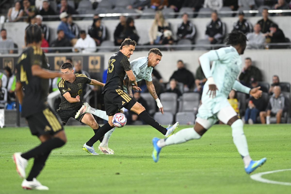 LAFC defender Aaron Long (33) holds down Colorado Rapids forward Rafael Navarro (9) during an MLS game between LAFC and Colorado Rapids on Wednesday, April 22, 2026 at BMO Stadium In Los Angeles Calif at BMO Stadium in Los Angeles Calif