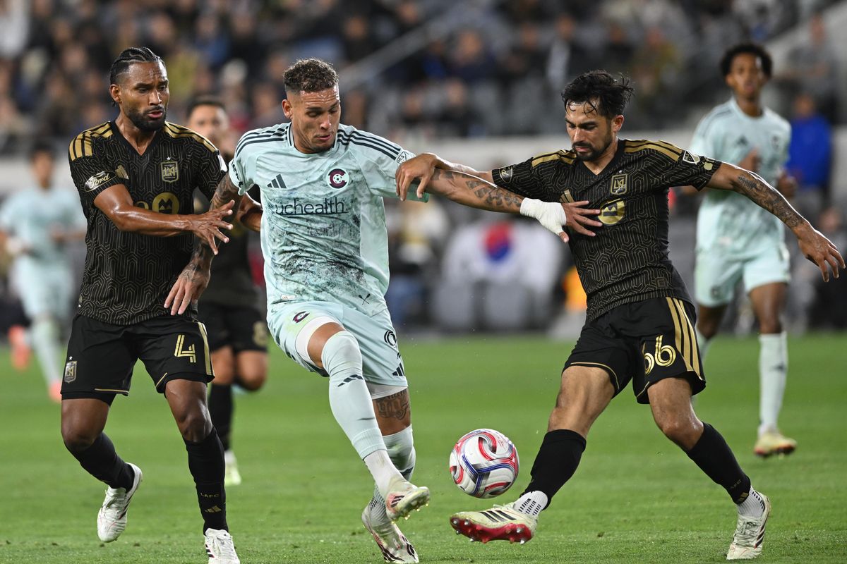 Colorado Rapids forward Rafael Navarro (9) battles for control against LAFC defenders Eddie Segura (4) and Mathieu Choinière (66) during an  MLS game between LAFC and Colorado Rapids on Wednesday, April 22, 2026 at BMO Stadium In Los Angeles Calif at BMO Stadium in Los Angeles Calif