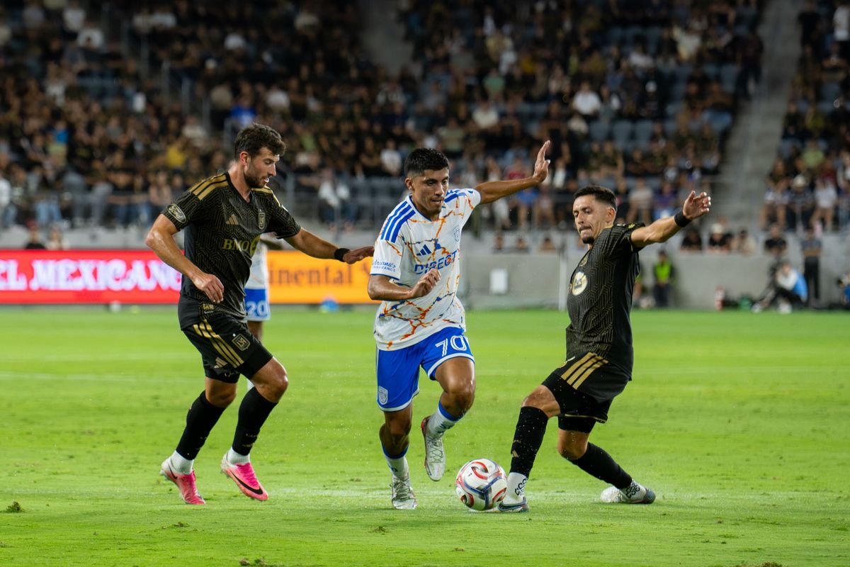 San Diego FC midfielder Alejandro Alvarado Jr. (70) dribbles past defenders during an MLS soccer game against Los Angeles FC, Saturday, August 15, 2026 in Los Angeles, California.