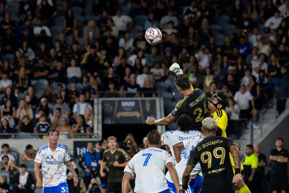 Los Angeles FC defender Ryan Hollingshead (24) jumps for the ball against San Diego FC goalkeeper CJ dos Santos (1) during an MLS soccer game, Saturday, August 15, 2026 in Los Angeles, California.