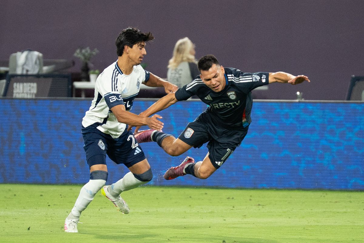 San Diego FC Forward Hirving Lozano (11) is fouled hard during an MLS match against Vancouver Whitecaps FC on July 19, 2025 at Snapdragon Stadium in San Diego, CA.