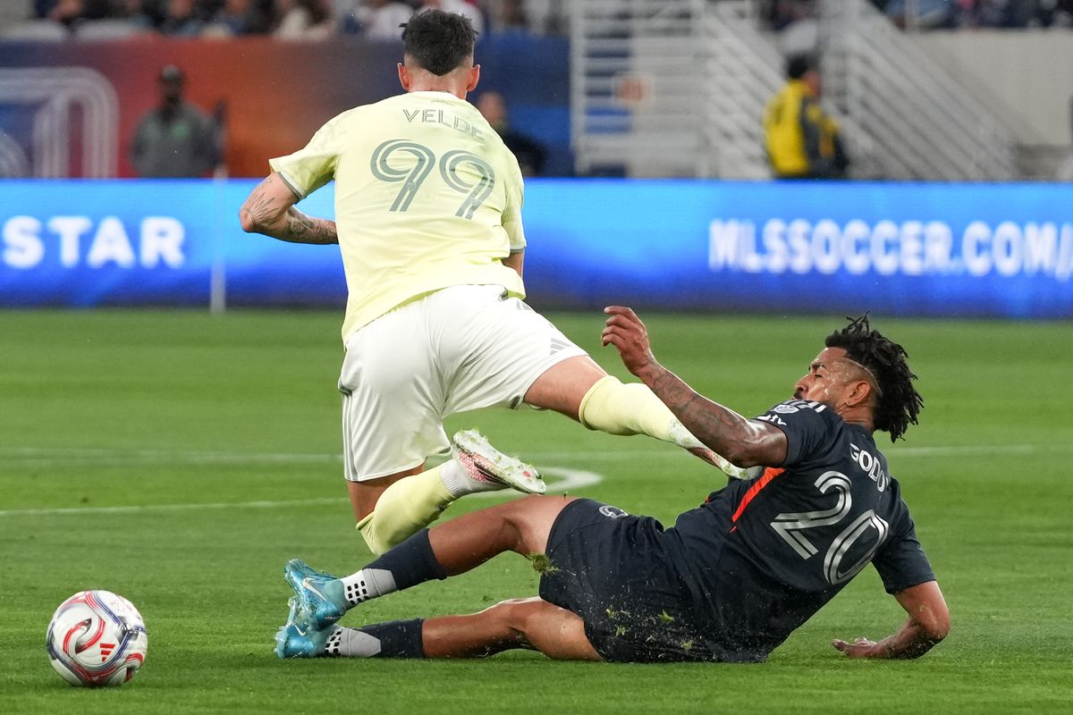 San Diego FC midfielder Aníbal Godoy (20) slide tackles Portland Timbers forward Kristoffer Velde (99) during an MLS soccer game, Saturday April 25, 2026 in San Diego, California.