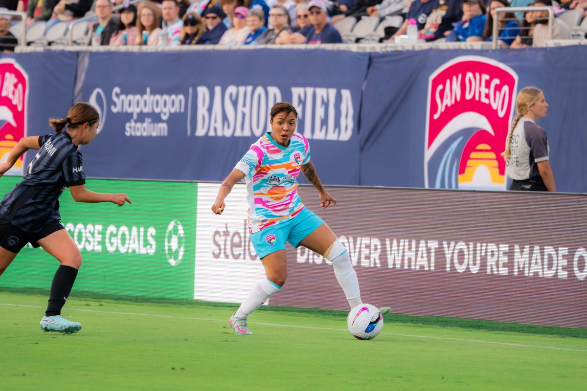 San Diego Wave Midfielder Gia Corley #11 running the ball past the defender during a match against the Washington Spirit on June 22, 2025 in San Diego, CA.