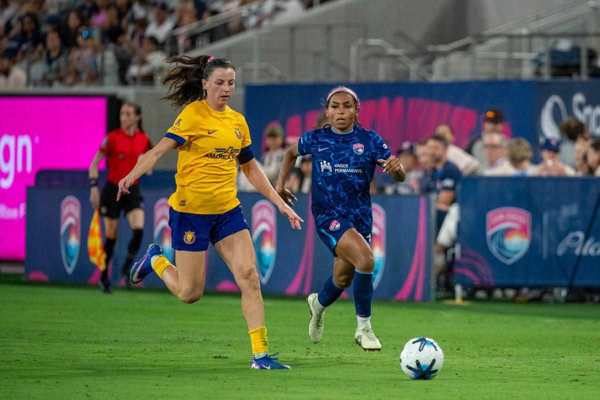 San Diego Wave FC defender Perle Morroni (right) sprints toward the ball against Utah Royals FC forward Paige Cronin during an NWSL soccer game, Friday, August 21, 2026 in San Diego, California.