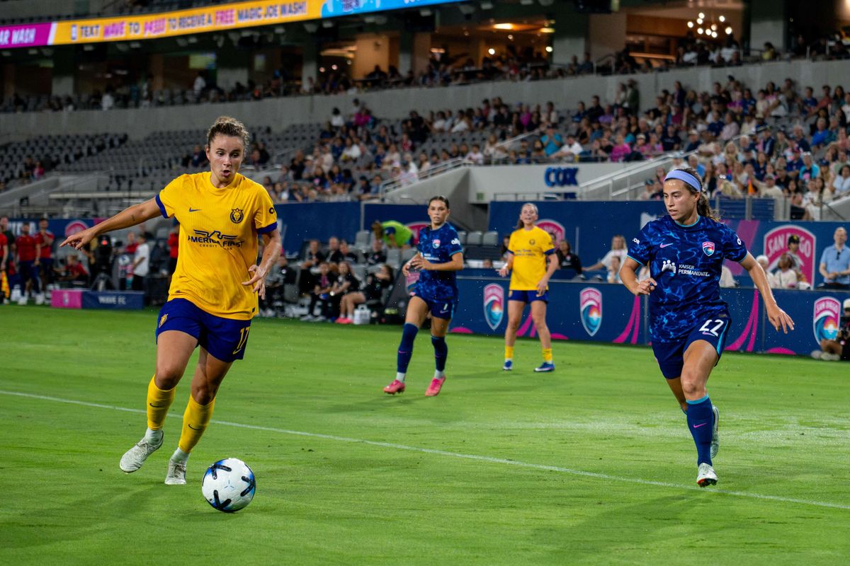 Utah Royals FC midfielder Ana Tejada (left) wins the ball against San Diego Wave FC midfielder Lia Godfrey during an NWSL soccer game, Friday, August 21, 2026 in San Diego, California.