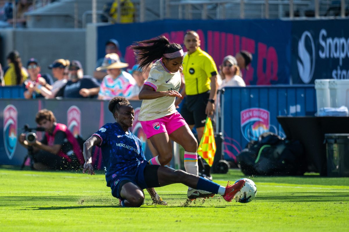 San Diego Wave FC defender Perle Morroni is tackled by NC Courage forward Chioma Okafor during an NWSL soccer game, Saturday, September 12, 2026 in San Diego, California.