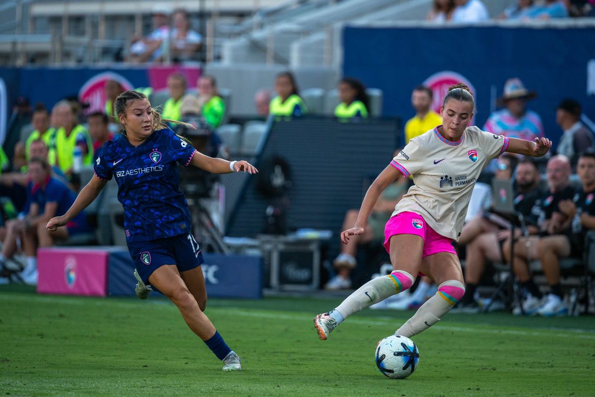 San Diego Wave FC defender Brooklyn Courtnall turns away from NC Courage midfielder Erica Meg Parkinson during an NWSL soccer game, Saturday, September 12, 2026 in San Diego, California.