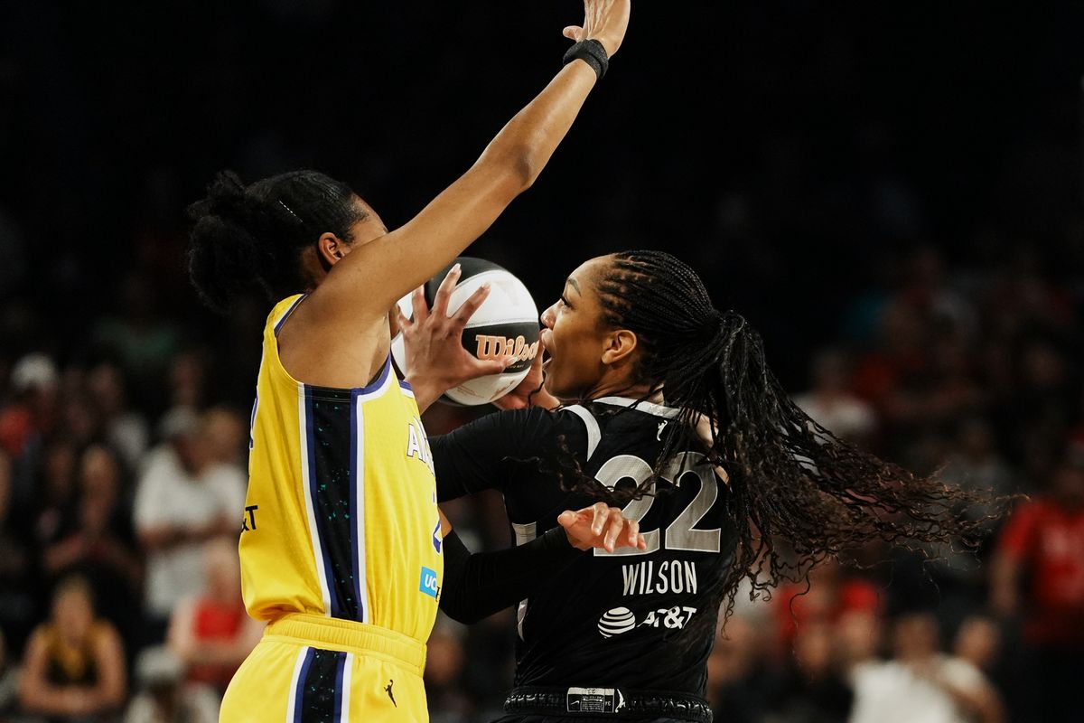 Las Vegas Aces center A’ja Wilson (22) goes around Los Angeles Sparks Azurá Stevens (23) during WNBA game against Los Angeles Sparks on Friday May 30, 2025 in Las Vegas.  