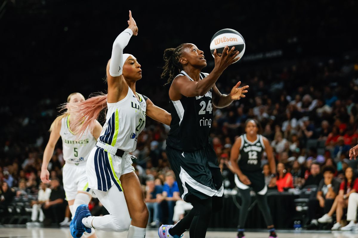  Las Vegas Aces guard Jewell Loyd (24) goes for a lay-up as Dallas Wings guard DiJonai Carrington (21) attempts to block the shot during a WNBA game between the Las Vegas Aces and the Dallas Wings, Friday June 13, 2025 in Las Vegas, Nev.
