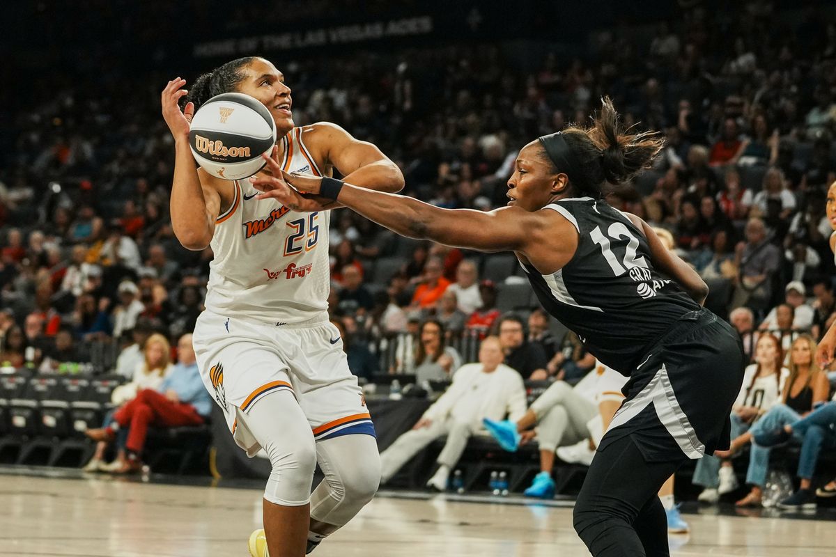 Pheonix Mercury forward Alyssa Thomas (25) eyes the basket while Las Vegas Aces guard Chelsea Gray (12) tries to gain control of the ball during WNBA game against Las Vegas Aces on Sunday June 15, 2025 in Las Vegas.  