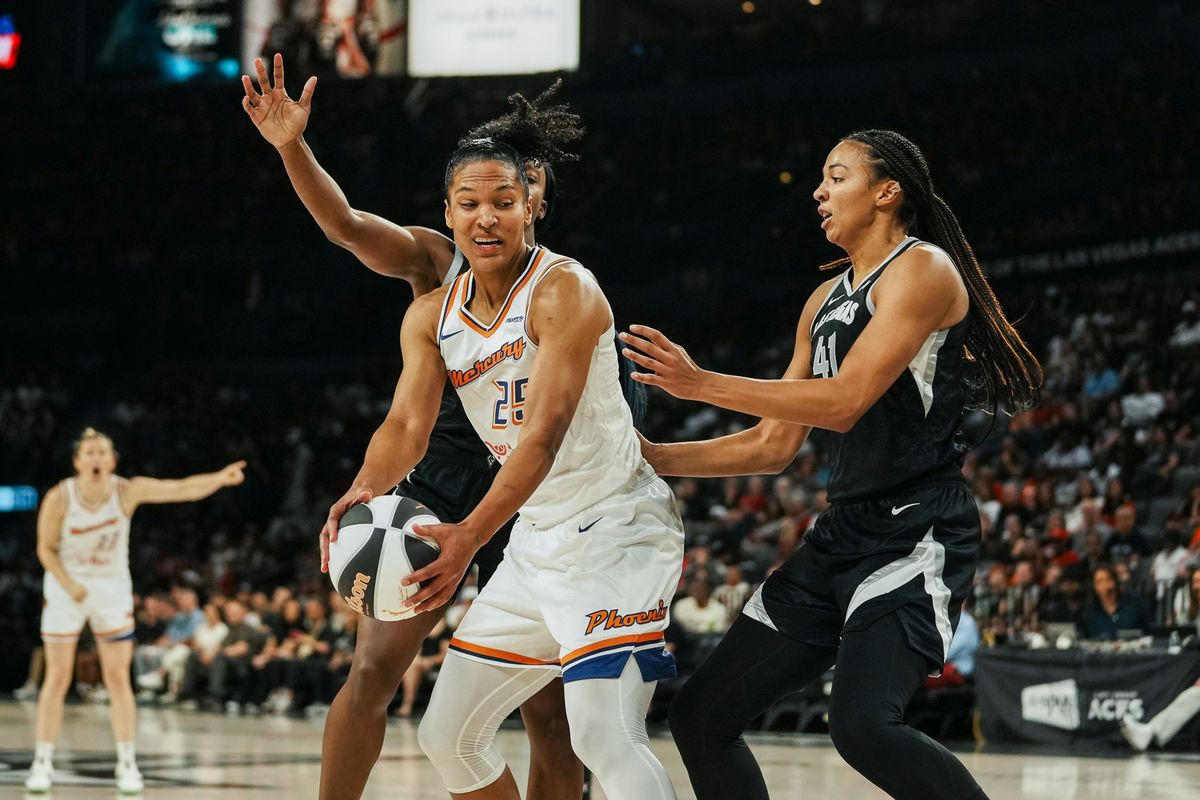 Pheonix Mercury forward Alyssa Thomas (25) scans the court while guarded by Las Vegas Aces guard Dana Evans and center Kiah Stokes (41) during WNBA game against Las Vegas Aces on Sunday June 15, 2025 in Las Vegas.  