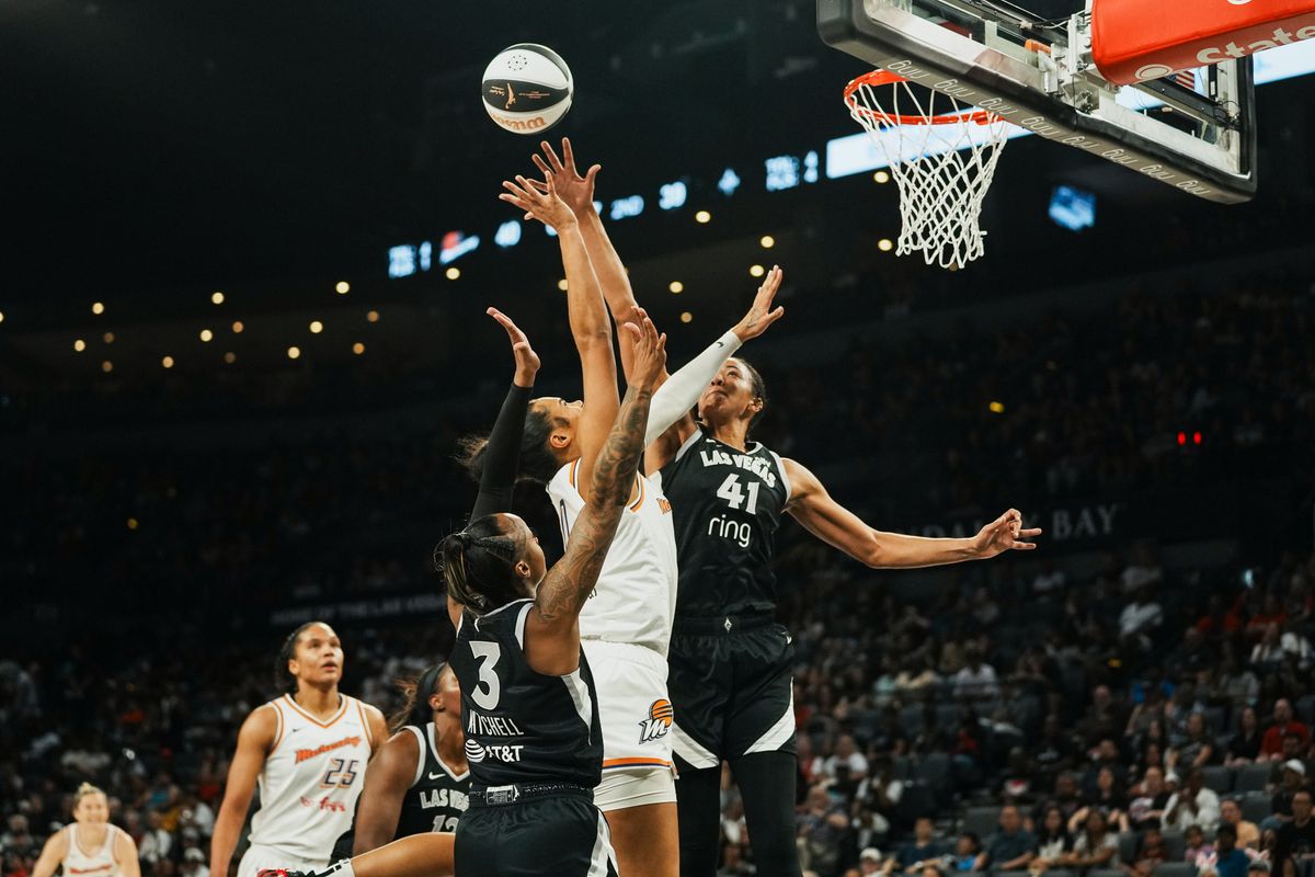 Pheonix Mercury forward Satou Sabally (0) shoots the ball while Las Vegas Aces center Kiah Stokes and Tiffany Mitchell (3) try to block the shot during WNBA game against Las Vegas Aces on Sunday June 15, 2025 in Las Vegas.  