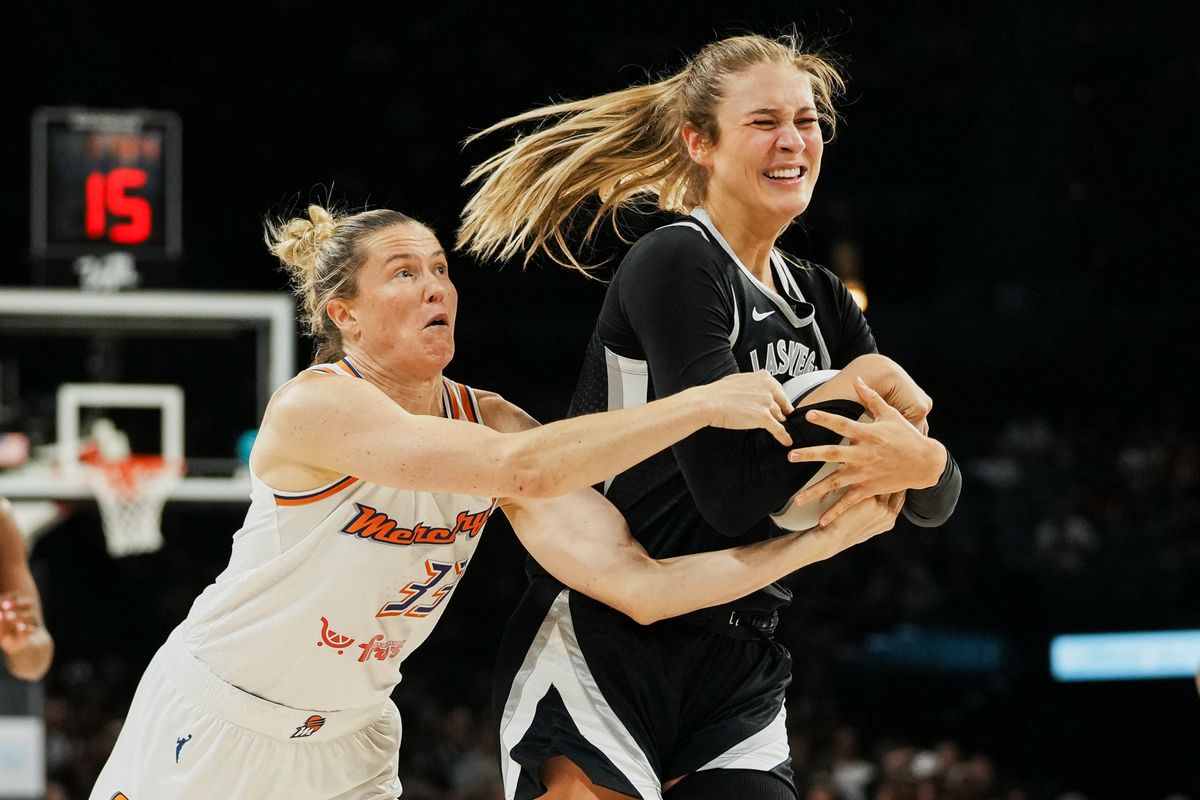 Las Vegas Aces guard Elizabeth Kitley (33)  and Pheonix Mercury Sami Whitcomb (33) battle for possession of the ball during WNBA game against Pheonix Mercury on Sunday June 15, 2025 in Las Vegas.  