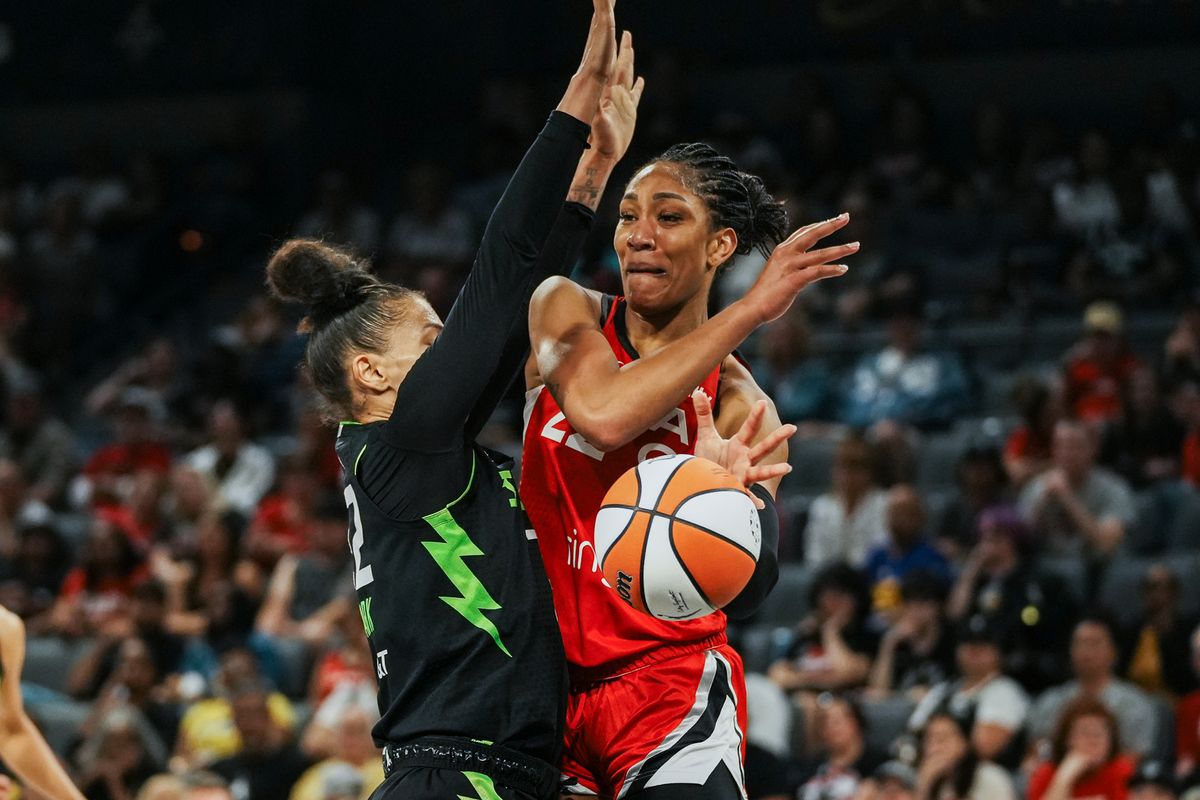 Las Vegas Aces center A’ja Wilson (22) passes the ball around Seattle Storm forward Alysha Clark (32) during WNBA game against Seattle Storm on Friday June 20 2025 in Las Vegas.