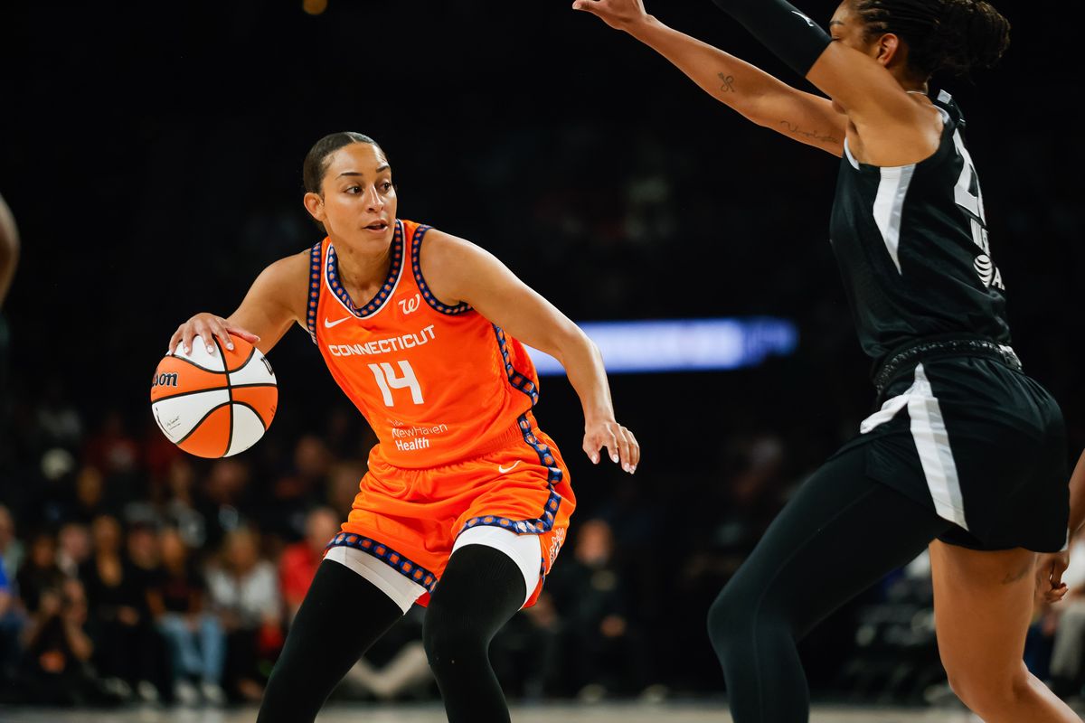 Connecticut Sun guard Bria Hartley (14) dribbles the ball as Las Vegas Aces forward A’ja Wilson (22) guards her during a WNBA game between the Las Vegas Aces and the Connecticut Sun, Wednesday June 25, 2025 in Las Vegas, Nev.