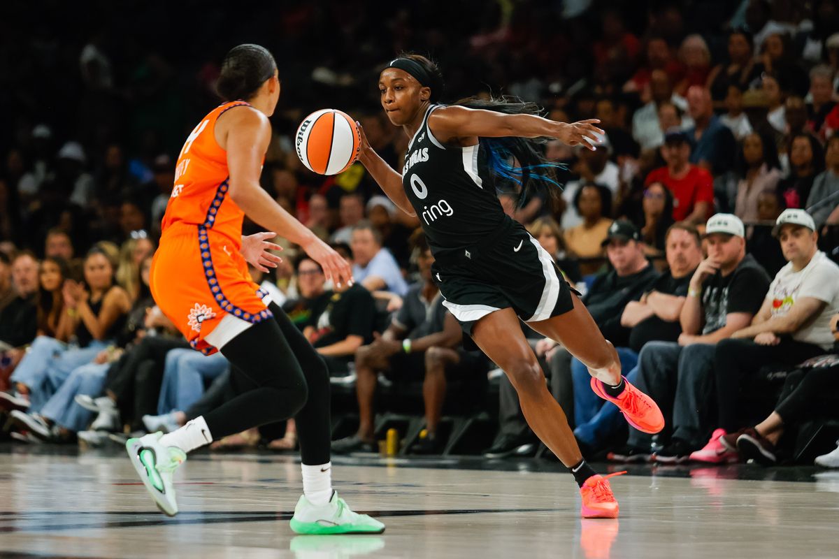 Las Vegas Aces guard Jackie Young (0) passes the ball with one hand during a WNBA game between the Las Vegas Aces and the Connecticut Sun, Wednesday June 25, 2025 in Las Vegas, Nev.