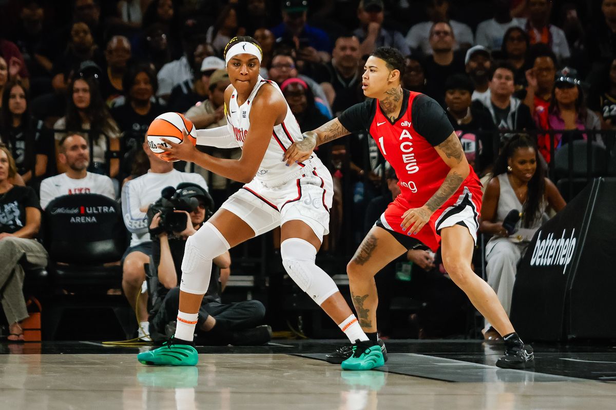 Washington Mystics forward Aaliyah Edwards (24) gets the ball at the post as Las Vegas Aces forward Kirsten Bell (1) defends her during a WNBA game between the Las Vegas Aces and the Washington Mystics, Thursday June 26, 2025 in Las Vegas, Nev.