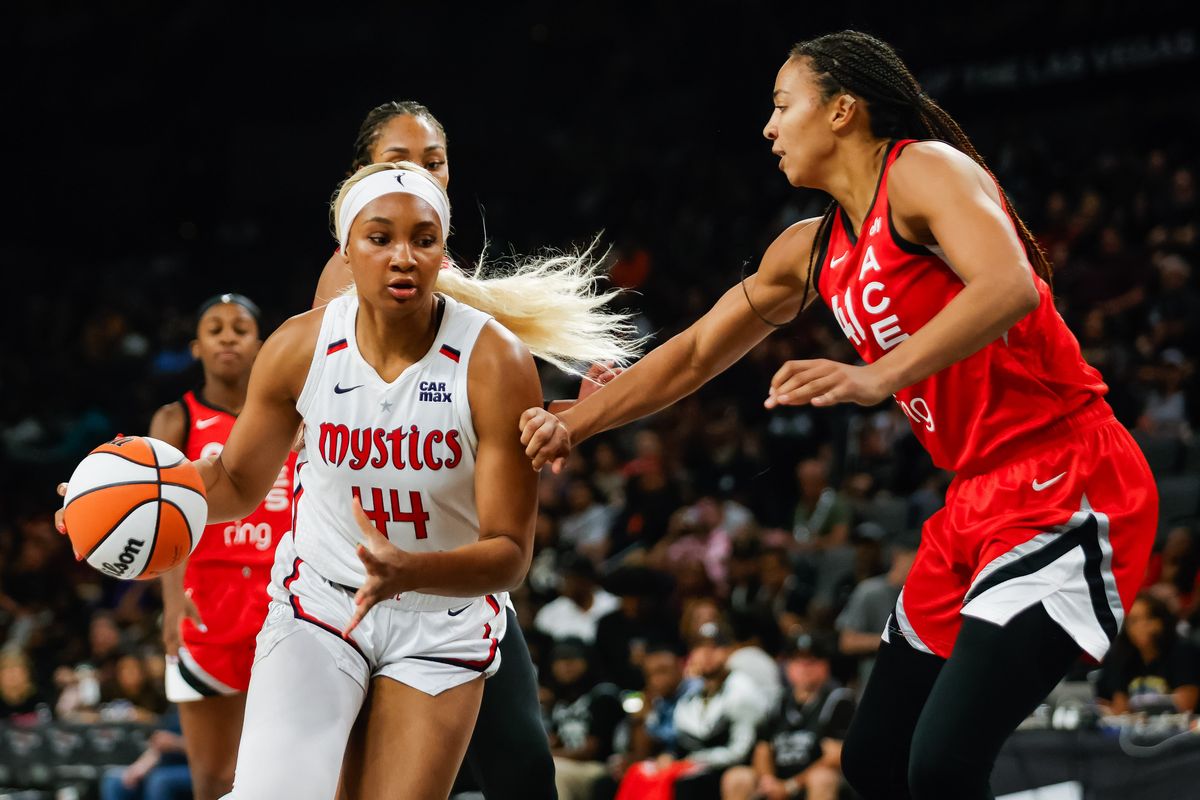 Washington Mystics forward Kiki Iriafen (44) drives to the basket as Las Vegas Aces center Kiah Stokes (41) defends during a WNBA game between the Las Vegas Aces and the Washington Mystics, Thursday June 26, 2025 in Las Vegas, Nev.
