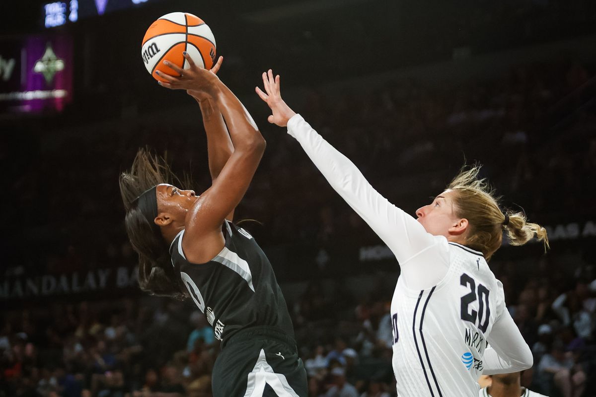 Las Vegas Aces guard Jackie Young (0) shoots the ball as Golden State Valkyries guard Kate Martin (20) contests Young’s shot during a WNBA game between the Las Vegas Aces and the Golden State Valkyries, Saturday July 12, 2025 in Las Vegas, Nev.
