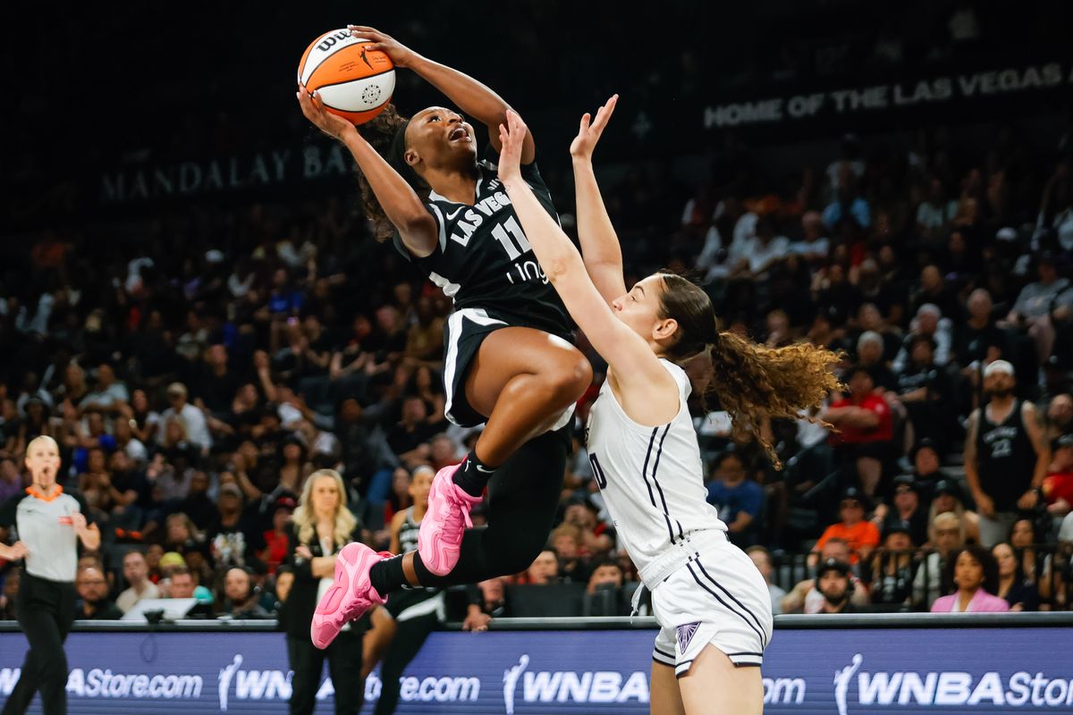 Las Vegas Aces guard Dana Evans (11) goes for a lay-up as Golden State Valkyries guard Carla Leite (0) attempts to block Evans during a WNBA game between the Las Vegas Aces and the Golden State Valkyries, Saturday July 12, 2025 in Las Vegas, Nev.