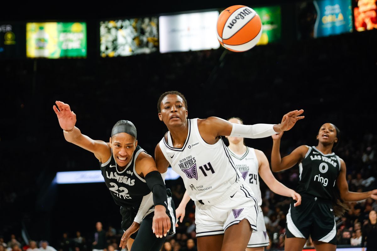 Las Vegas Aces forward A’ja Wilson (22) and Golden State Valkyries center Temi Fágbénlé (14) both go after a loose ball during a WNBA game between the Las Vegas Aces and the Golden State Valkyries, Saturday July 12, 2025 in Las Vegas, Nev.