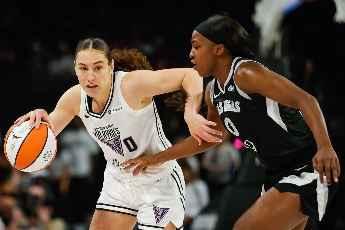 Golden State Valkyries guard Carla Leite (0) dribbles towards the basket while Las Vegas Aces guard Jackie Young (0) defends her during a WNBA game between the Las Vegas Aces and the Golden State Valkyries, Sunday August 3, 2025 in Las Vegas, Nev.