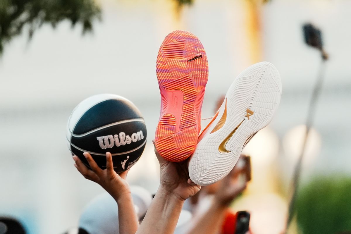 Las Vegas Aces fans hold Jackie Young’s and A’ja Wilson’s signature shoes during the Aces’ championship parade, Friday October 17, 2025 in Las Vegas, Nev. Las Vegas Aces fans hold Jackie Young’s and A’ja Wilson’s signature shoes during the Aces’ championship parade, Friday October 17, 2025 in Las Vegas, Nev.