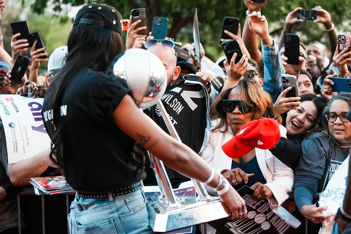 Las Vegas Aces fans reach to have their items signed by A’ja Wilson during the Aces’ championship parade celebration, Friday October 17, 2025 in Las Vegas, Nev. Las Vegas Aces fans reach to have their items signed by A’ja Wilson during the Aces’ championship parade celebration, Friday October 17, 2025 in Las Vegas, Nev.