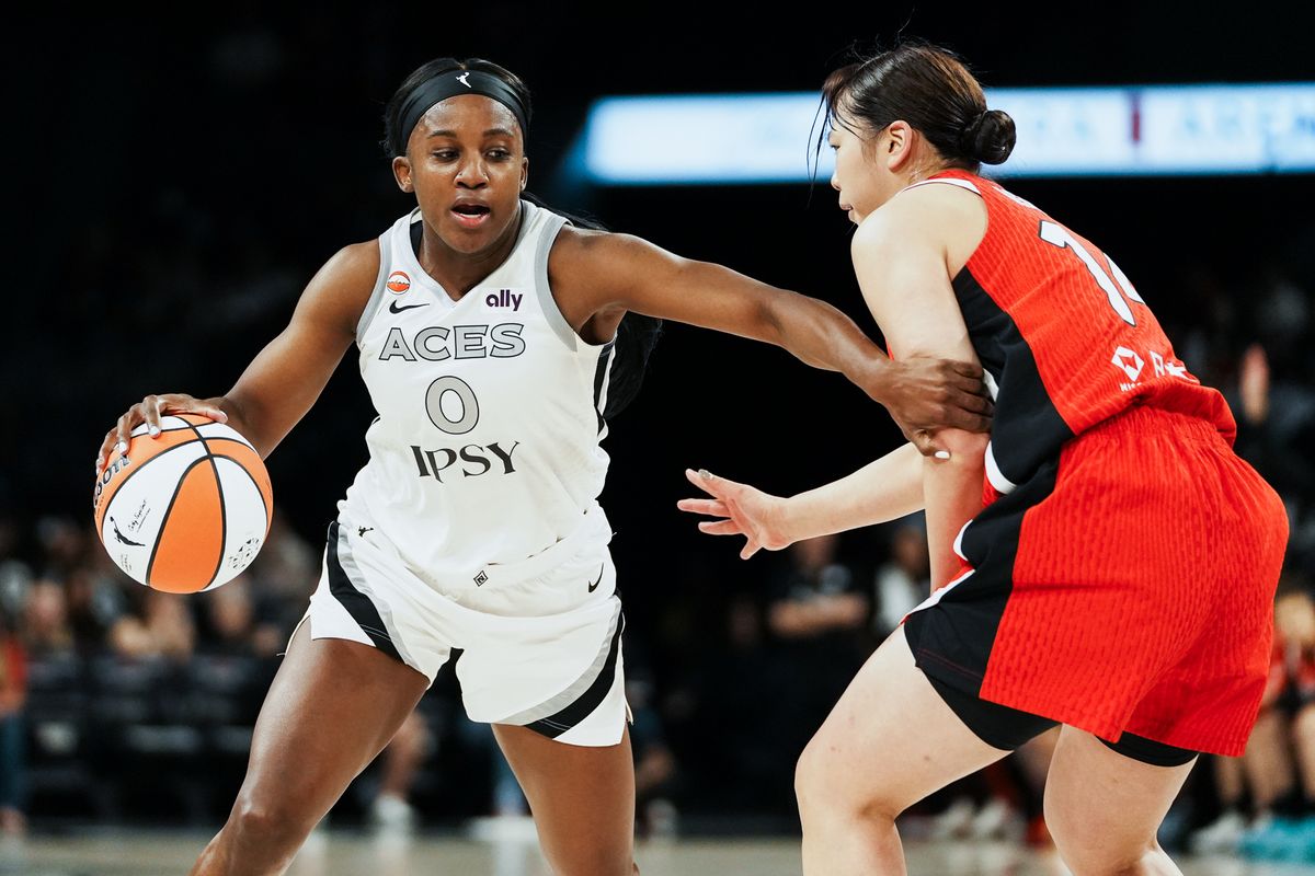 Las Vegas Aces guard Jackie Young (0) takes the ball down the court while guarded by Japan center Azusa Asahina (14) during first half of WNBA preseason game on Sunday April 26, 2026 at Michelob Ultra Arena in Las Vegas.