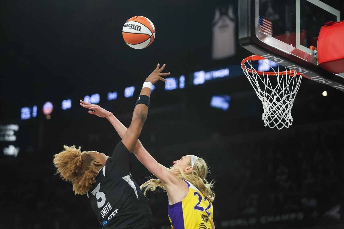 Las Vegas Aces forward NaLyssa Smith (3) goes for a lay-up as Los Angeles Sparks forward Cameron Brink (22) attempts to block the shot during a WNBA game between the Las Vegas Aces and the Los Angeles Sparks, Saturday May 23, 2026 in Las Vegas, Nev.