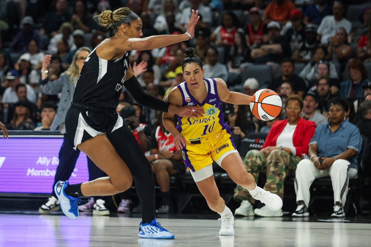 Los Angeles Sparks guard Kelsey Plum (10) dribbles towards the basket as Las Vegas Aces forward A’ja Wilson (22) defends her during a WNBA game between the Las Vegas Aces and the Los Angeles Sparks, Saturday May 23, 2026 in Las Vegas, Nev.