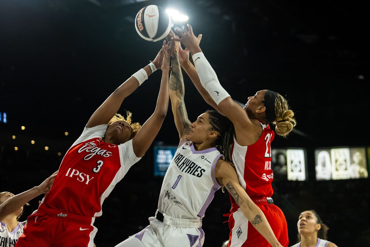 Las Vegas Aces forward NaLyssa Smith (3) and A’ja Wilson (22) jump for a rebound with Golden State Valkyries forward Gabby Williams (1) during a WNBA game between the Las Vegas Aces and the Golden State Valkyries, Saturday June 6, 2026 in Las Vegas, Nev. Las Vegas Aces forward NaLyssa Smith (3) and A’ja Wilson (22) jump for a rebound with Golden State Valkyries forward Gabby Williams (1) during a WNBA game between the Las Vegas Aces and the Golden State Valkyries, Saturday June 6, 2026 in Las Vegas, Nev.