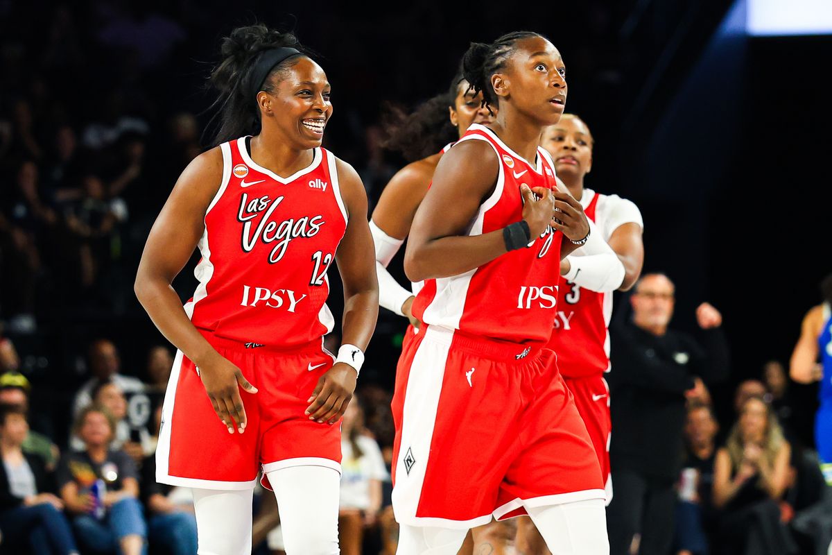 Las Vegas Aces guard Chelsea Gray (12) smiles after her teammate guard Jewell Loyd (24) scored a three point shot against the Dallas Wings on Thursday, June 25, 2026, at Michelob ULTRA Arena in Las Vegas, Nevada.