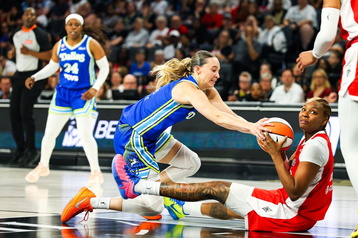 Dallas Wings guard Paige Bueckers (5) lunges for the ball possessed by Las Vegas Aces forward Nalyssa Smith (3) during a WNBA game on Thursday, June 25, 2026, at Michelob ULTRA Arena in Las Vegas, Nevada.