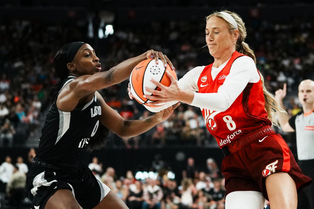 Indiana Fever guard Sophie Cunningham (8) grips the ball while Aces Jackie Young tries to gain control during WNBA game against the Las Vegas Aces on Sunday July 5, 2026 at T-Mobile Arena in Las Vegas. Indiana Fever guard Sophie Cunningham (8) grips the ball while Aces Jackie Young tries to gain control during WNBA game against the Las Vegas Aces on Sunday July 5, 2026 at T-Mobile Arena in Las Vegas.