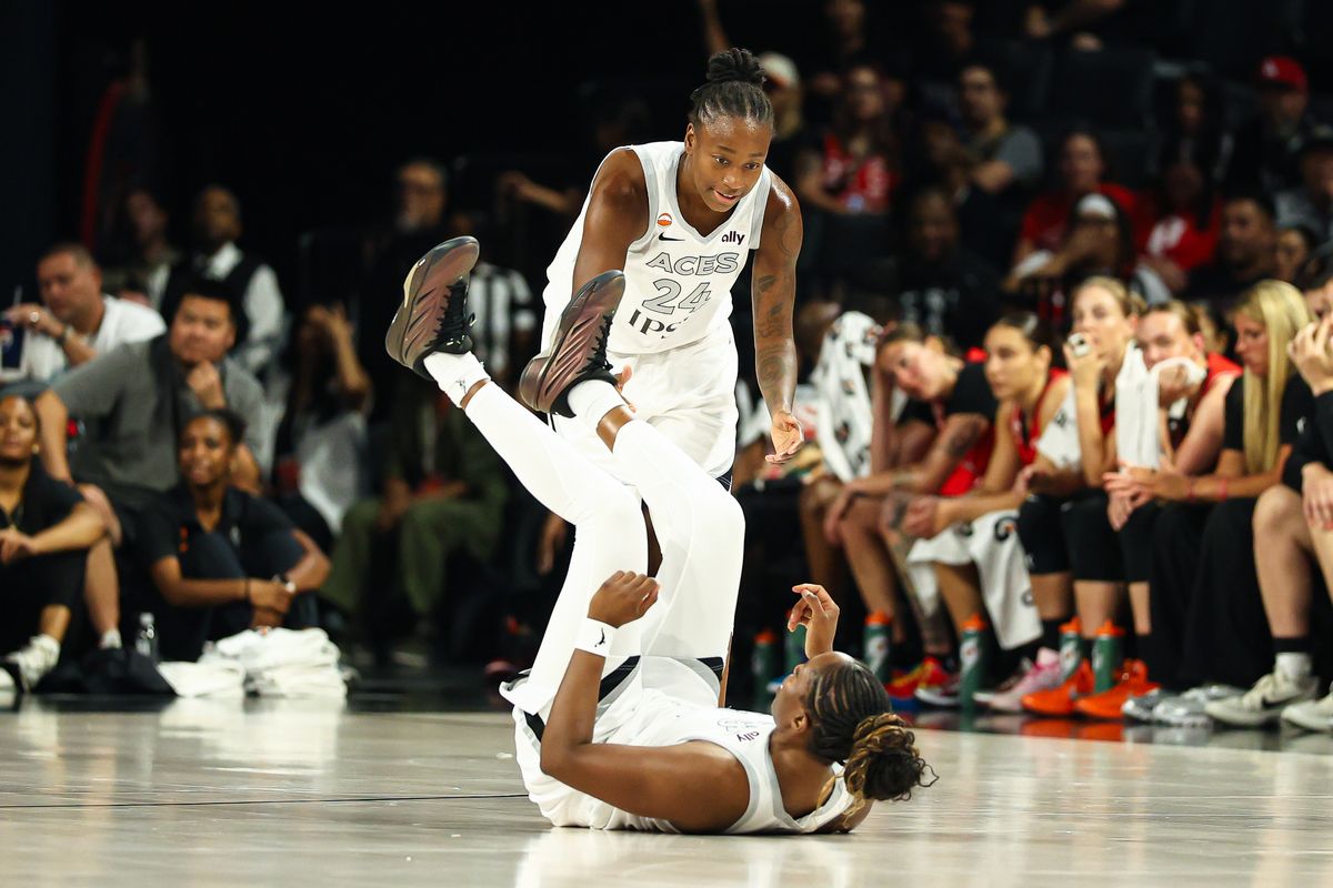 Las Vegas Aces guard Jewell Loyd (24) helps her teammate Chelsea Gray (12) after Gray was fouled in a WNBA game against the Portland Fire on Tuesday, July 28, 2026, at Michelob ULTRA Arena in Las Vegas, Nevada.