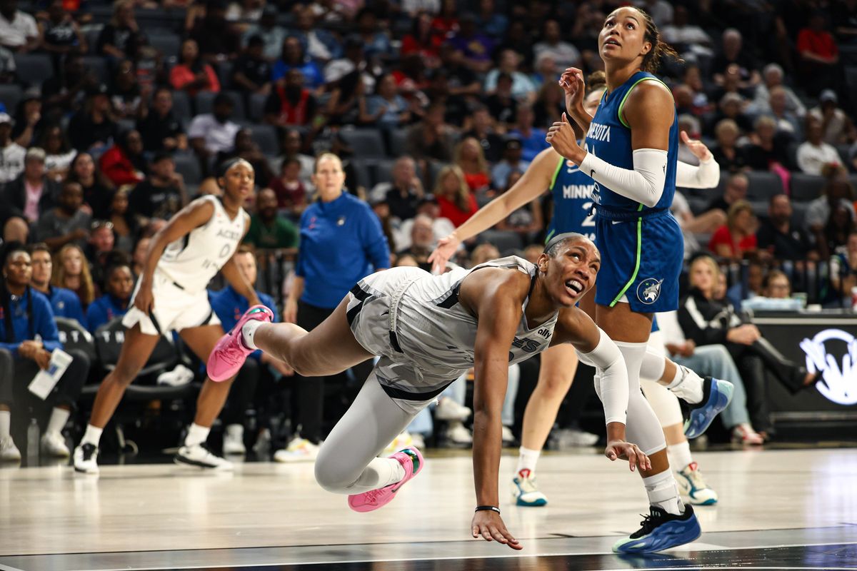 Las Vegas Aces center A'ja Wilson (22) falls after drawing a foul against Minnesota Lynx forward Napheesa Collier (24) during a WNBA game on Saturday, August 15, 2026, at Michelob ULTRA Arena in Las Vegas, Nevada. Las Vegas Aces center A'ja Wilson (22) falls after drawing a foul against Minnesota Lynx forward Napheesa Collier (24) during a WNBA game on Saturday, August 15, 2026, at Michelob ULTRA Arena in Las Vegas, Nevada.