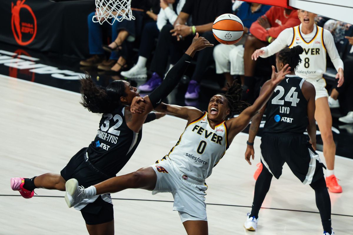 Las Vegas Aces forward Cheyenne Parker-Tyus (32) blocks a shot attempt from Indiana Fever guard Kelsey Mitchell (0) in the first quarter of Round 1 Game 1 of the 2026 WNBA Playoffs on Sunday, September 27, 2026, at Michelob ULTRA Arena in Las Vegas, Nevada.