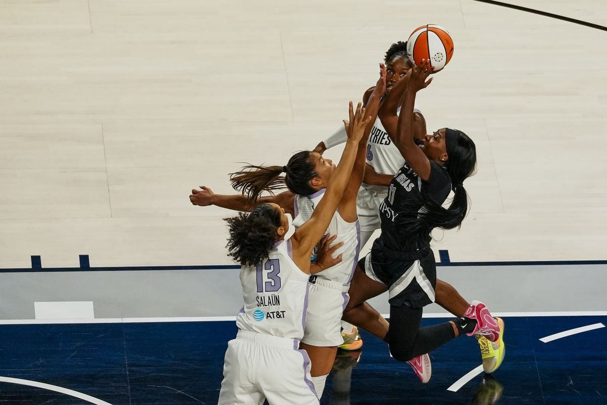 Las Vegas Aces guard Dana Evans (11) attempts to shoot he ball over Golden State Valkyries forward Janelle Salaun (13), Kaitlyn Chen (2) and Kalia Charles (6) during first quarter of WNBA game against the Golden State Valkyries on Friday October 9, 2026 at Michelob Ultra Arena in Las Vegas. Las Vegas Aces guard Dana Evans (11) attempts to shoot he ball over Golden State Valkyries forward Janelle Salaun (13), Kaitlyn Chen (2) and Kalia Charles (6) during first quarter of WNBA game against the Golden State Valkyries on Friday October 9, 2026 at Michelob Ultra Arena in Las Vegas.