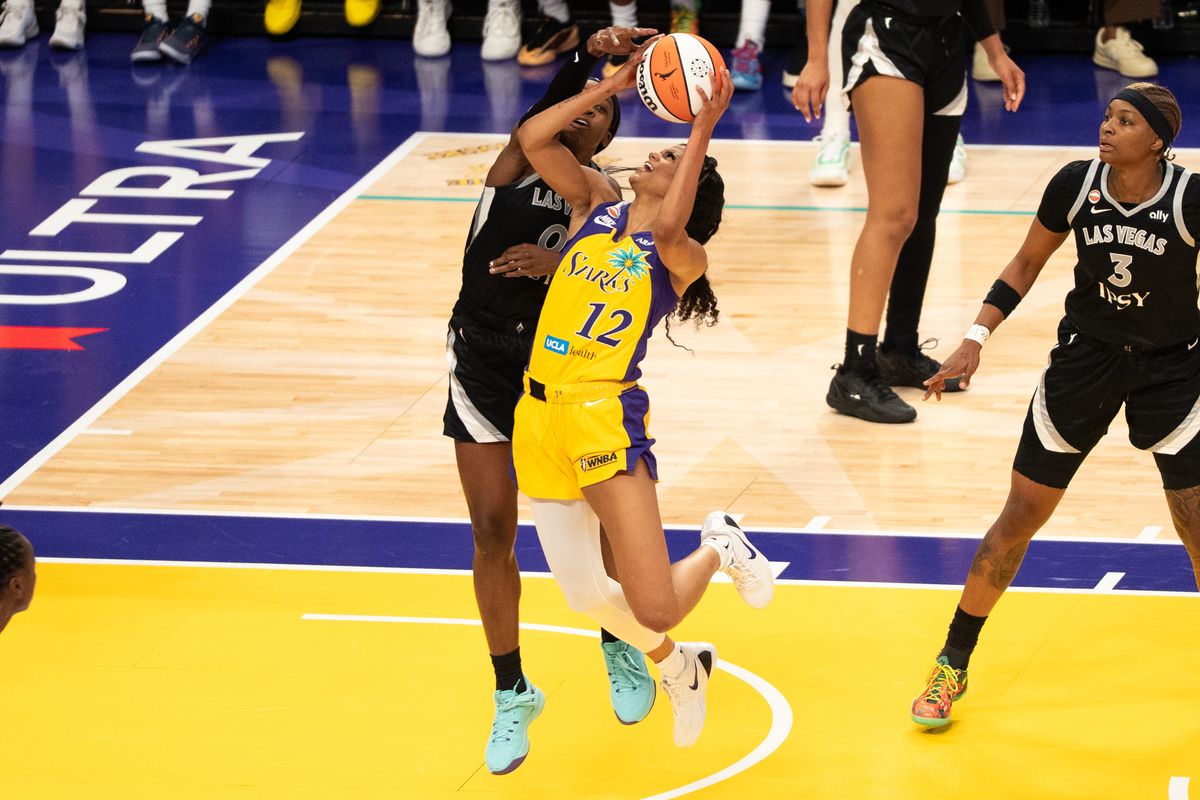 LA Sparks guard Rae Burrell (12) attacks the rim and scores while getting fouled during a WNBA basketball game against the Las Vegas Aces, Sunday May 10th, 2026 in Los Angeles, California. LA Sparks guard Rae Burrell (12) attacks the rim and scores while getting fouled during a WNBA basketball game against the Las Vegas Aces, Sunday May 10th, 2026 in Los Angeles, California.