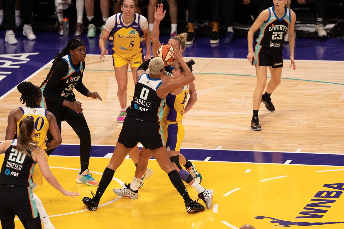 Los Angeles Sparks Guard Kelsey Plum (10) tries to split by two defenders during a WNBA game against the New York Liberty, Sunday June 21st, 2026 in Los Angeles, California. Los Angeles Sparks Guard Kelsey Plum (10) tries to split by two defenders during a WNBA game against the New York Liberty, Sunday June 21st, 2026 in Los Angeles, California.