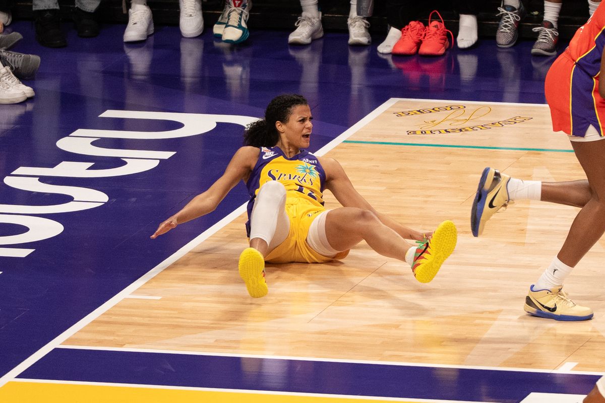 Los Angeles Sparks Guard Rae Burrell (12) gets shoved to the ground but no call during a WNBA game against the Phoenix Mercury, Wednesday July 22nd, 2026 in Los Angeles, California.