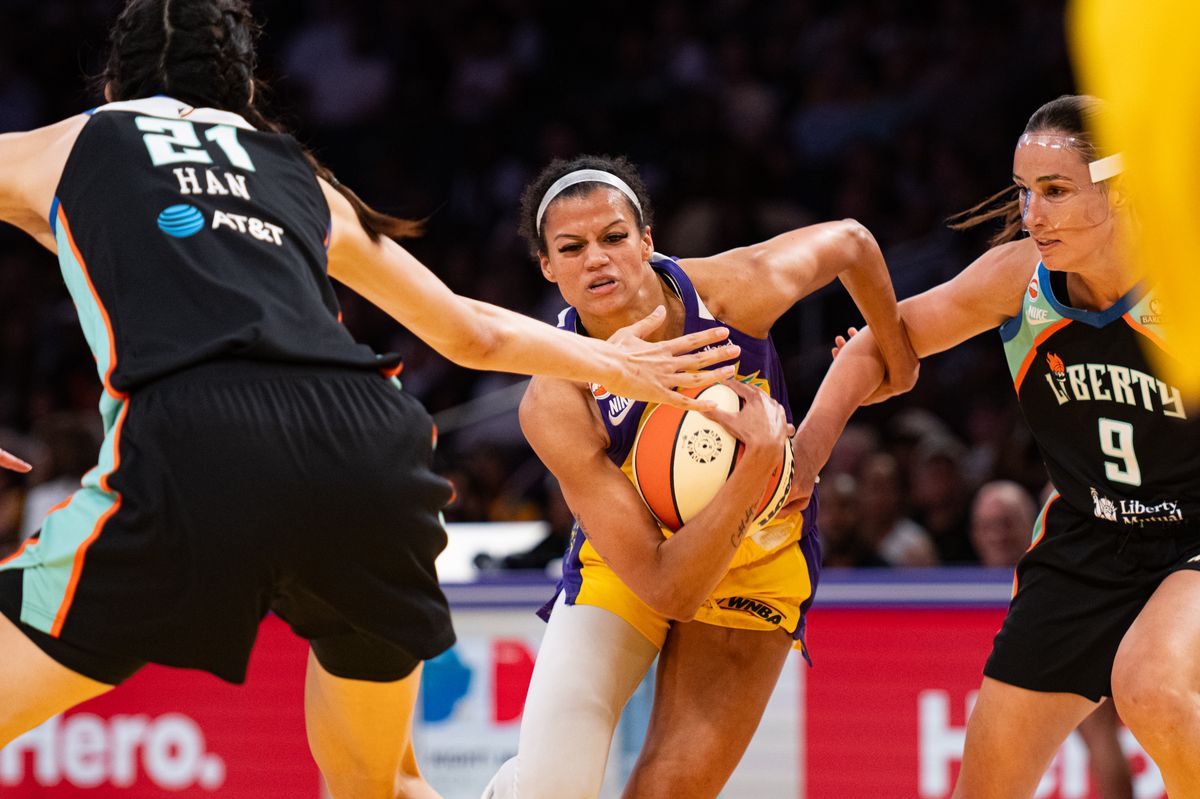 Los Angeles Sparks guard Rae Burrell (12) protects the ball against NY Liberty defenders during a match between New York Liberty and Los Angeles Sparks on Tuesday, July 28, 2026 at Crypto.com Arena