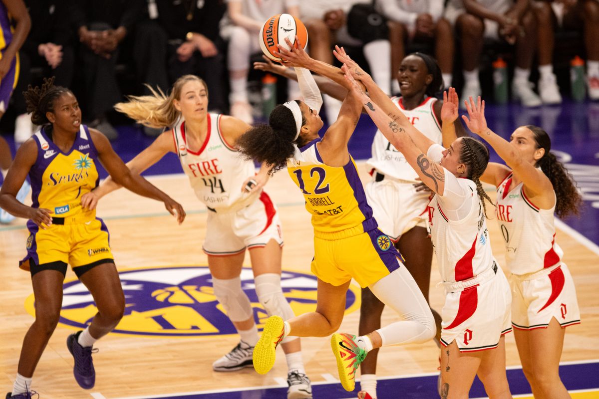 Los Angeles Sparks guard Rae Burrell (12) drives against 3 defenders during an NBA match between Portland Fire and Los Angeles Sparks on Sunday, September 20, 2026 at Crypto.com Arena in Los Angeles, California.